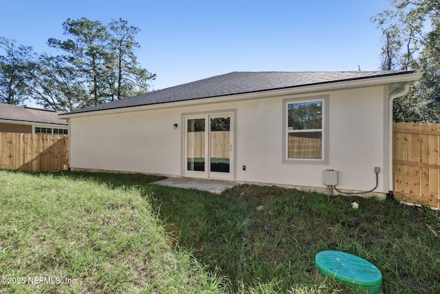 back of house featuring a yard