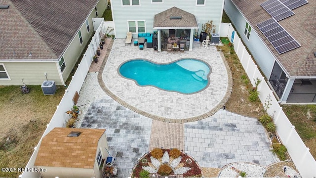 view of pool featuring a patio and central AC unit