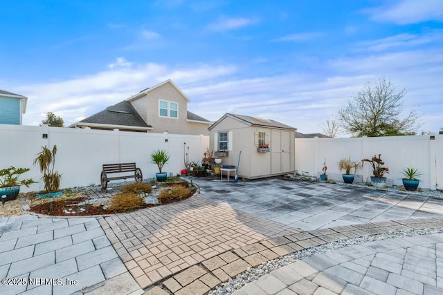 back of property with a storage unit and a patio area