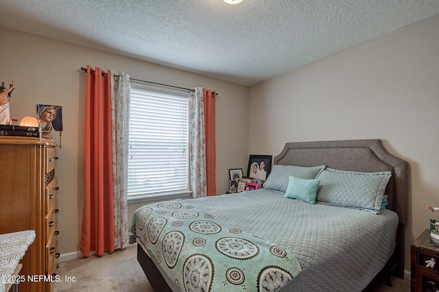 carpeted bedroom with a textured ceiling