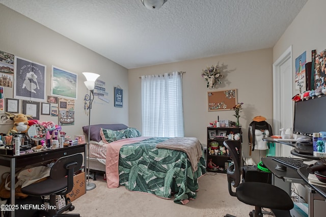 bedroom with carpet floors and a textured ceiling