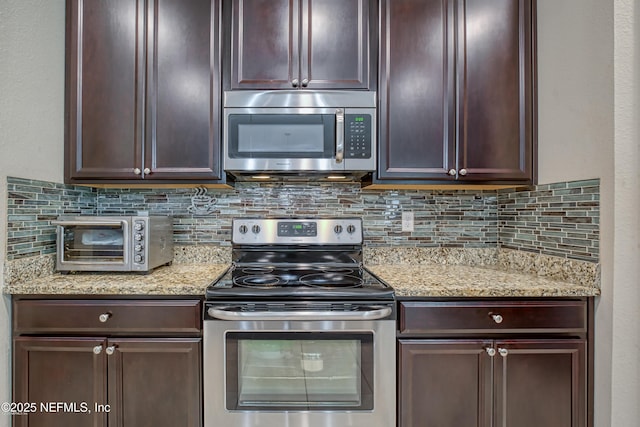 kitchen featuring appliances with stainless steel finishes, light stone countertops, dark brown cabinets, and backsplash