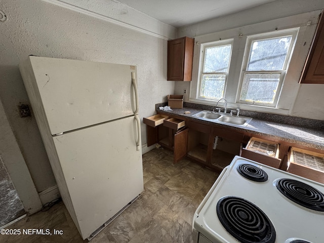 kitchen featuring white appliances and sink