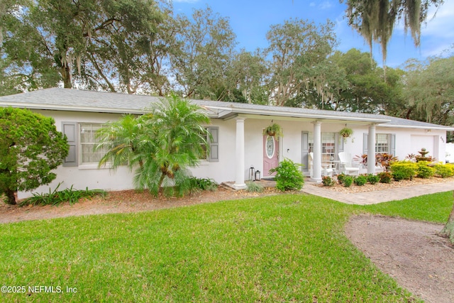 ranch-style house featuring a garage, a front yard, and covered porch