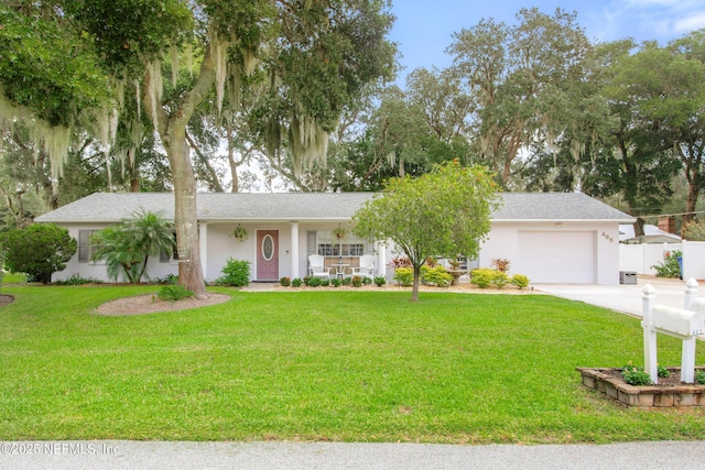 single story home featuring a garage, a front lawn, and covered porch