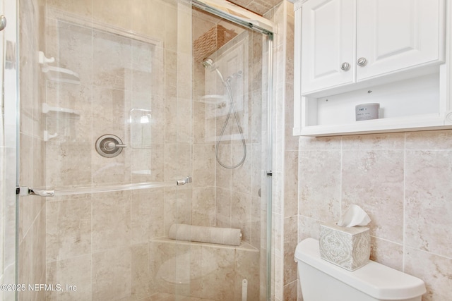 bathroom featuring an enclosed shower and toilet