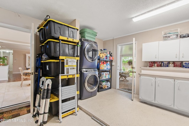 laundry room featuring stacked washer / drying machine and a textured ceiling