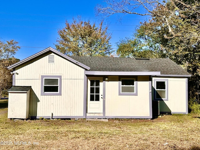 view of outbuilding with a yard