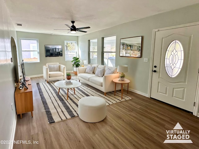 living room featuring hardwood / wood-style flooring and ceiling fan