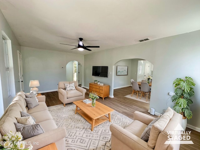 living room with ceiling fan and light hardwood / wood-style floors