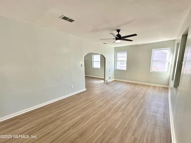 spare room with ceiling fan and light wood-type flooring