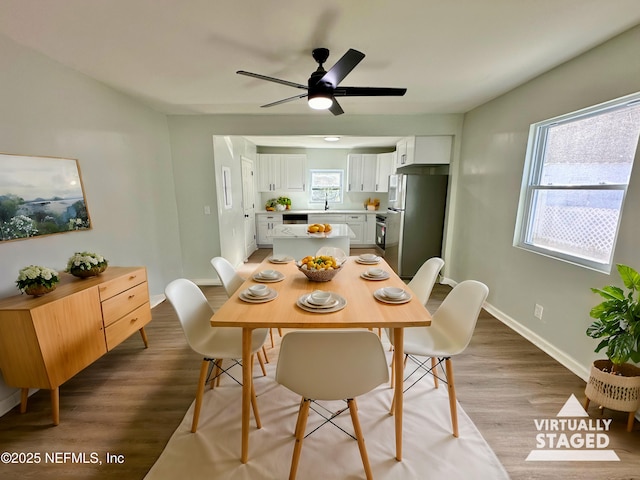 dining room featuring ceiling fan and light hardwood / wood-style flooring