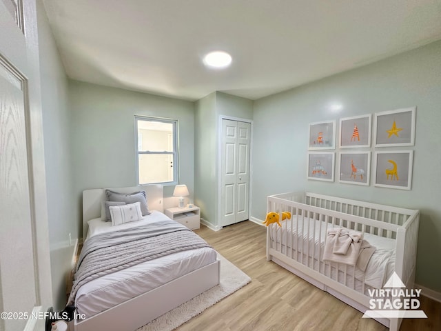 bedroom featuring light hardwood / wood-style floors and a closet