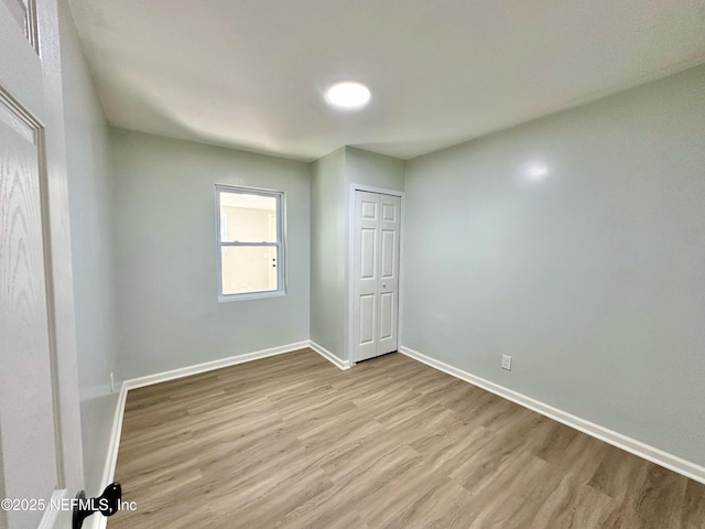 spare room with light hardwood / wood-style floors