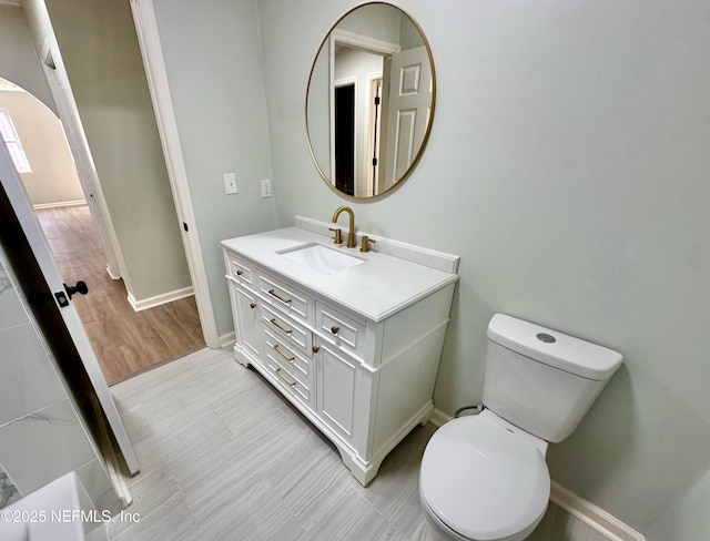 bathroom featuring vanity, hardwood / wood-style floors, and toilet