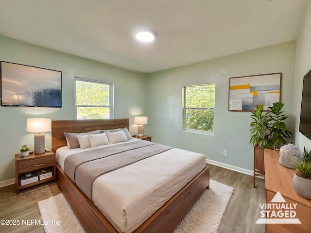 bedroom with hardwood / wood-style floors