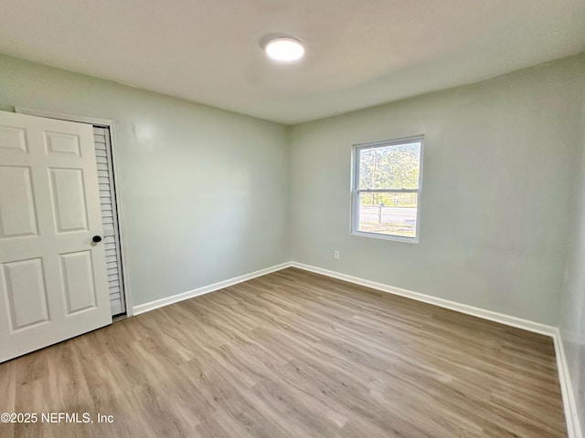 unfurnished bedroom featuring light wood-type flooring