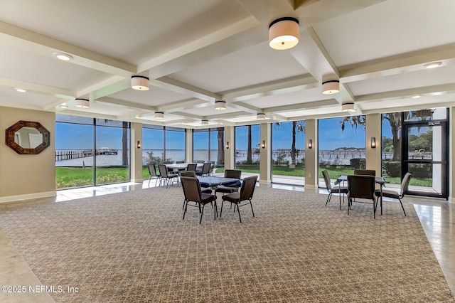 sunroom with coffered ceiling, beamed ceiling, and a water view