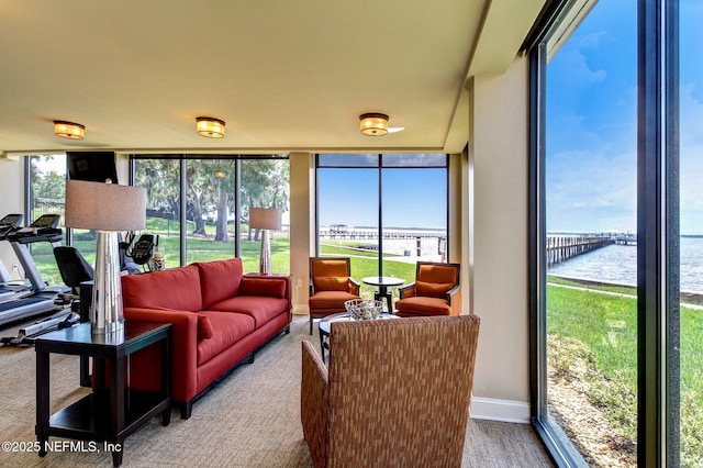 sunroom / solarium featuring a water view and a wealth of natural light