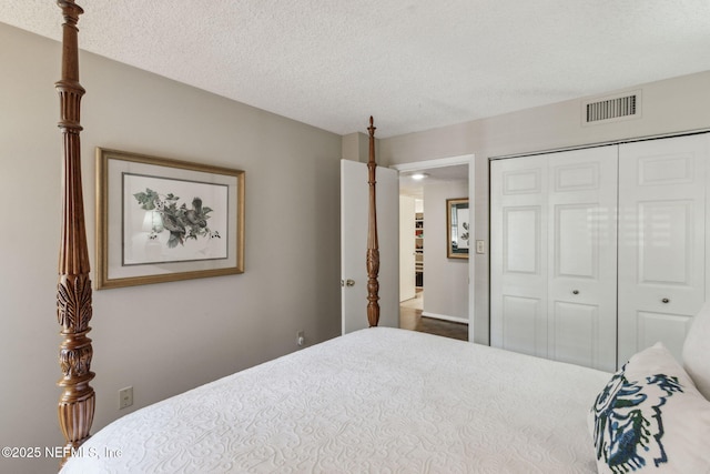 bedroom with a textured ceiling and a closet