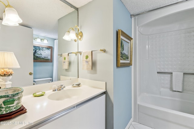 full bathroom featuring vanity, tub / shower combination, a textured ceiling, and toilet