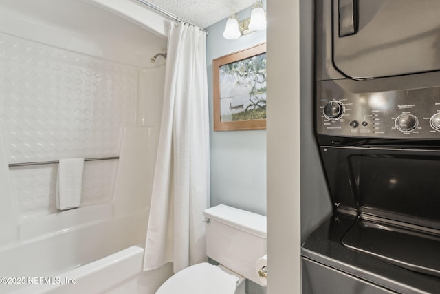 bathroom featuring shower / bathtub combination with curtain, stacked washer and dryer, toilet, and a textured ceiling