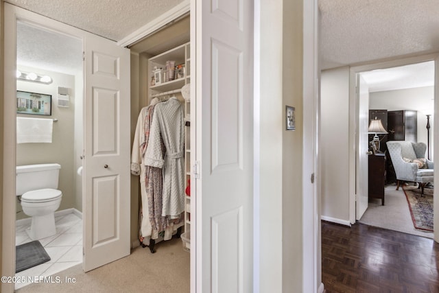 bathroom featuring toilet and a textured ceiling