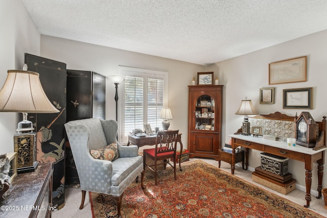 living area with light carpet and a textured ceiling