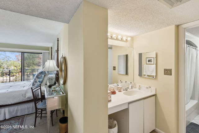 bathroom with vanity and a textured ceiling