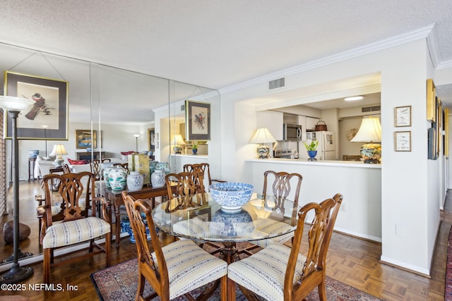 dining space with crown molding, dark parquet floors, and a textured ceiling