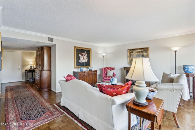 living room featuring parquet floors, ornamental molding, and a textured ceiling