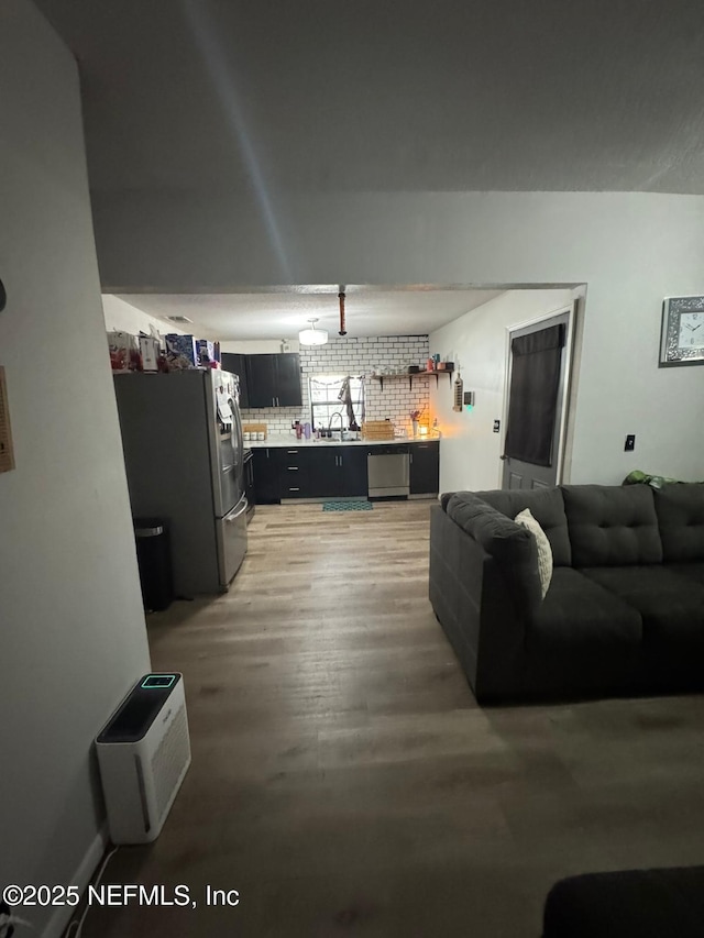 living room with sink and hardwood / wood-style floors