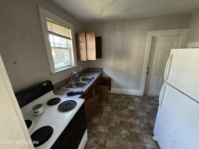 kitchen featuring white refrigerator, electric stove, and sink