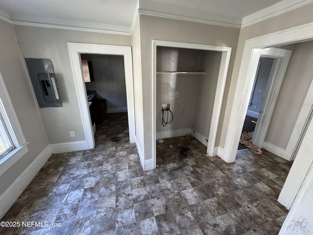 unfurnished bedroom featuring ornamental molding, electric panel, and a closet