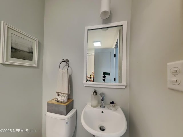 bathroom featuring sink and toilet