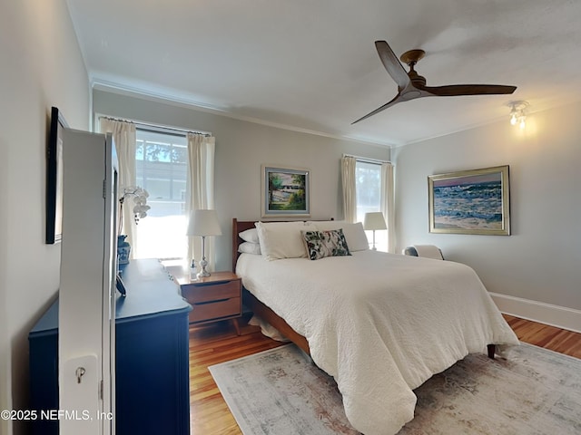 bedroom with ornamental molding, light hardwood / wood-style floors, and ceiling fan