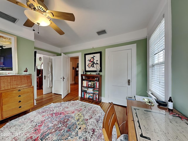 bedroom with ceiling fan and light hardwood / wood-style floors