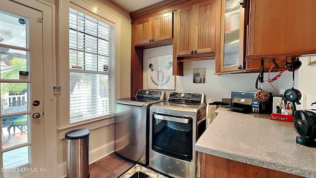 washroom with cabinets and washer and dryer