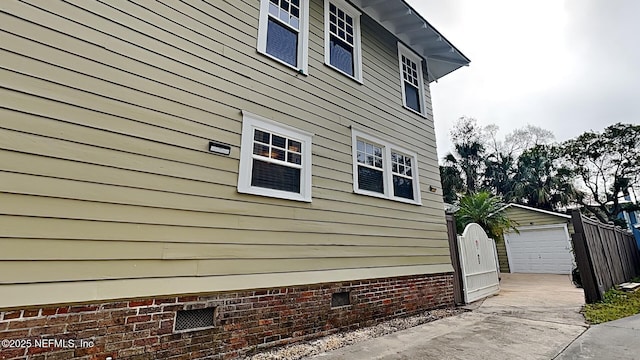 view of property exterior featuring an outbuilding and a garage