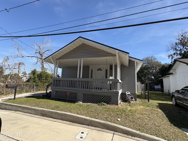 bungalow-style home featuring a porch and a front lawn