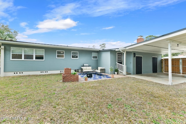 rear view of property with a yard, outdoor lounge area, and a patio area