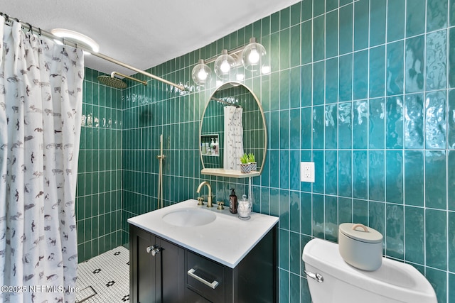 bathroom featuring walk in shower, vanity, toilet, and tile walls