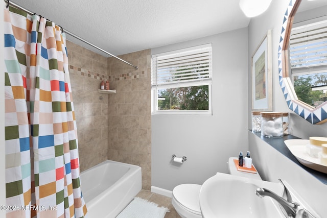 full bathroom with a textured ceiling, sink, toilet, shower / bathtub combination with curtain, and tile patterned floors