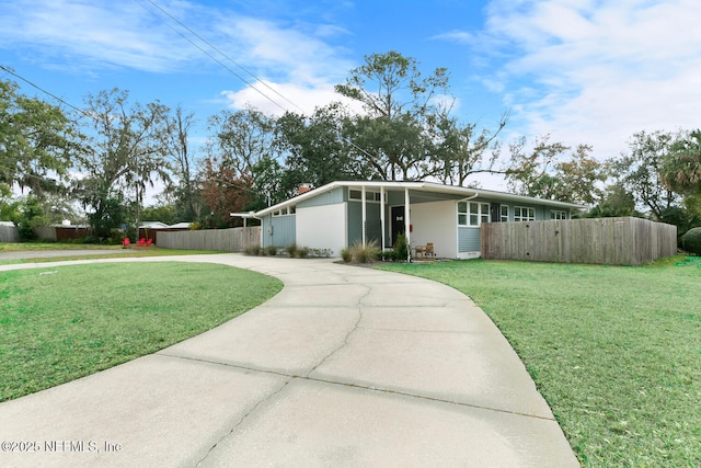 ranch-style house featuring a carport and a front yard