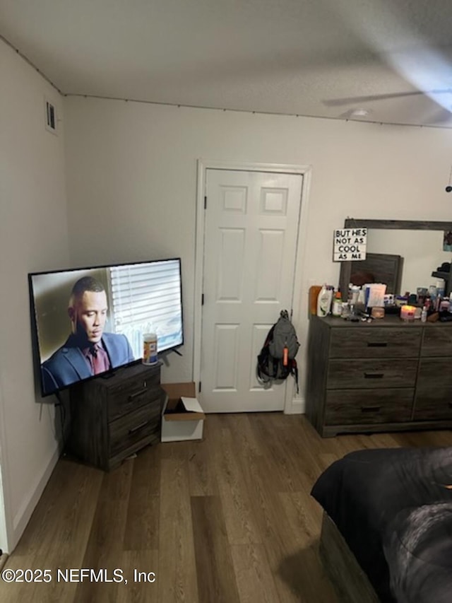 bedroom with dark wood-type flooring