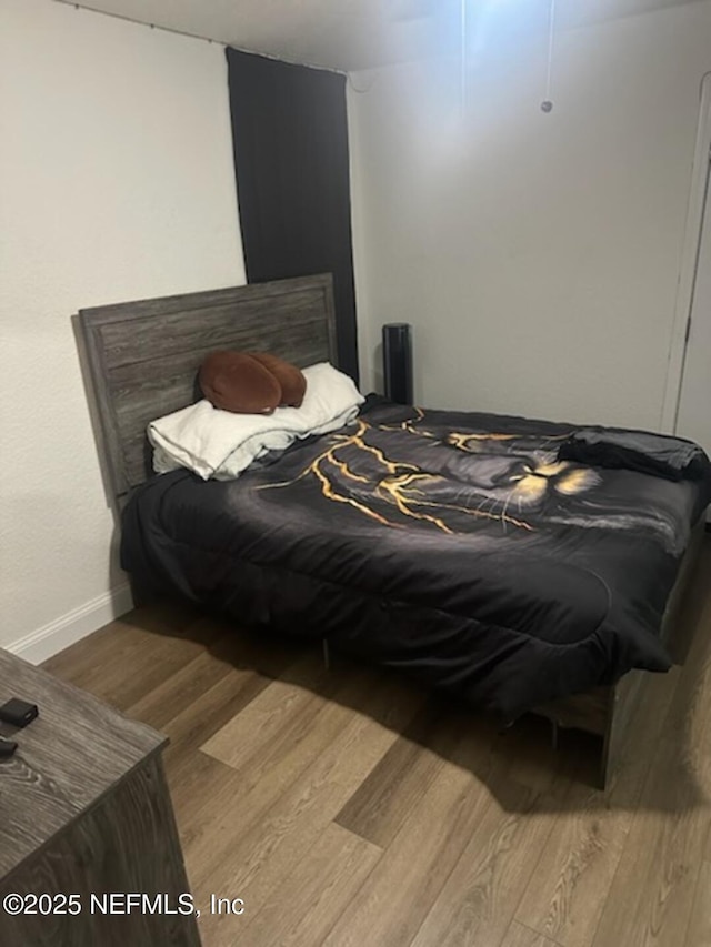 bedroom with hardwood / wood-style flooring