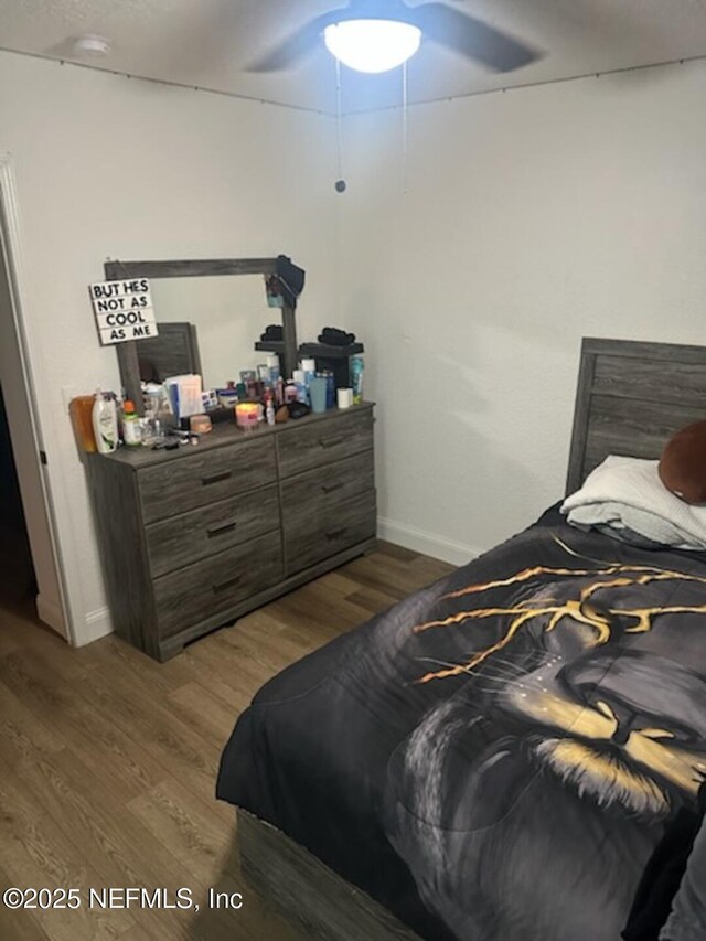 bedroom featuring ceiling fan and dark hardwood / wood-style flooring