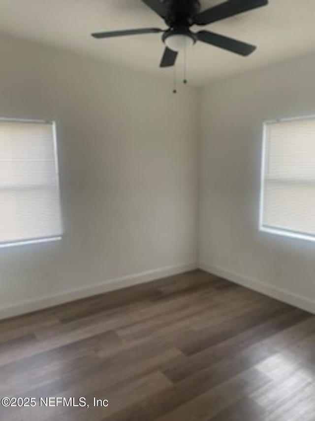 spare room with ceiling fan and dark hardwood / wood-style flooring