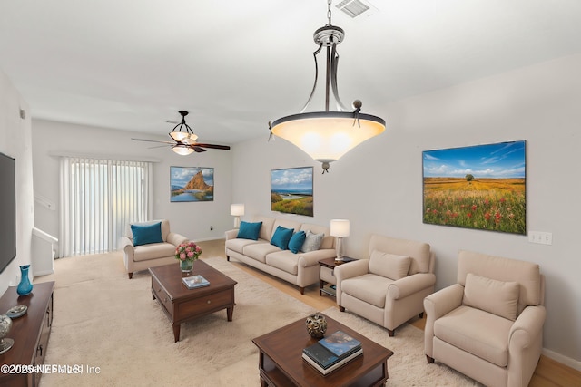 living room featuring light carpet and ceiling fan