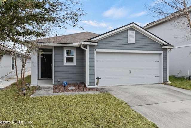 view of front of house with a garage and a front lawn